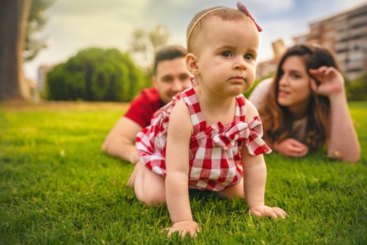 Portrait of happy young Family lying on grass . High quality photo