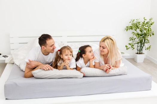 A young family with young children to bed in the bedroom.