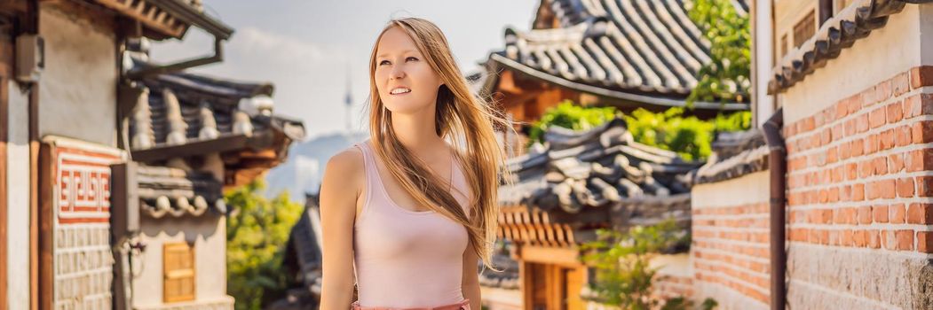 Young woman tourist in Bukchon Hanok Village is one of the famous place for Korean traditional houses have been preserved. Travel to Korea Concept. BANNER, LONG FORMAT