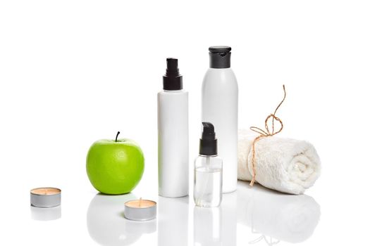 Natural spa beauty treatment cleansing products with apple on white background. The concept for advertising cosmetics. Still life. Copy space