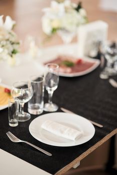 Table set for an event party or wedding reception. Empty wine glasses at a wedding celebration.