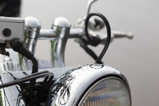 The close up of motorcycle wheel with headlight