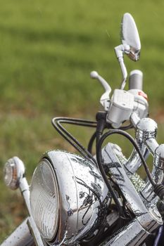 The close up of motorcycle wheel with headlight