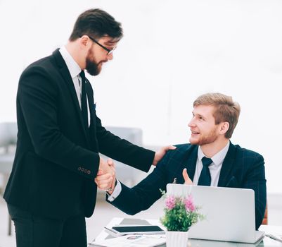 handshake Manager and employee in the workplace.photo with copy space