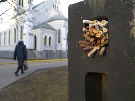 The element of the fence in which the parishioners of the Lutheran Church leave cigarette butts.