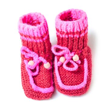 Knitted baby footwear on a white background.