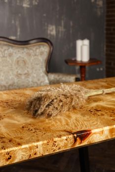 Wooden stylish table made of solid walnut with epoxy resin in stylish interior