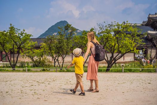 Mom and son tourists in Korea. Gyeongbokgung Palace grounds in Seoul, South Korea. Travel to Korea concept. Traveling with children concept.