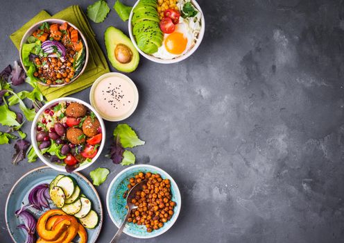 Mixed healthy vegetarian salads with vegetables, sweet potato, falafel, bulgur, avocado, eggs. Assorted buddha bowl salads background. Healthy dinner. Salad in bowl. Making ingredients. Space for text