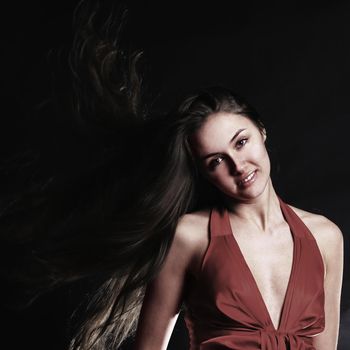 portrait of fashionable young woman in a red dress . isolated on a black background.photo with copy space