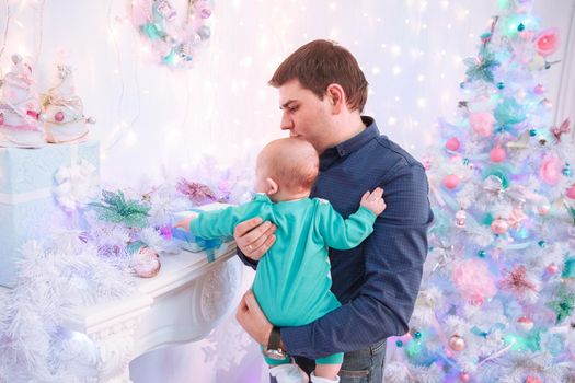 father and son standing next to a Christmas tree.happy fatherhood