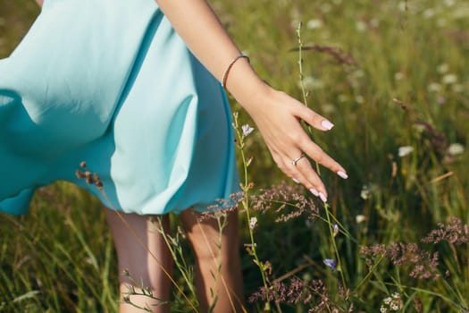 A woman's hand touches the grass