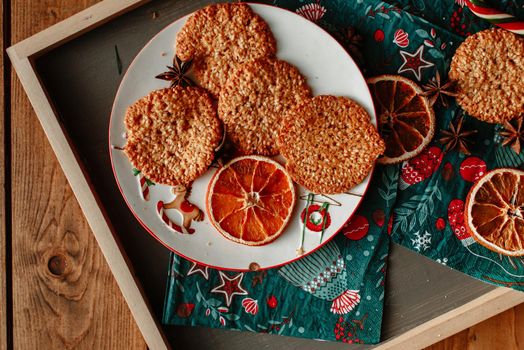 Oatmeal cookies on a tray under the Christmas tree