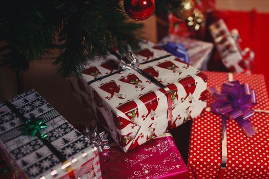 Christmas tree with Christmas toys. Gifts lying under the tree