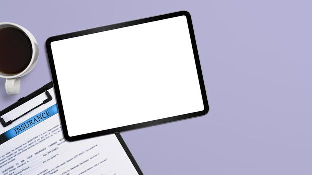 Top view digital tablet and insurance claim form on purple background. Blank screen for advertise text.