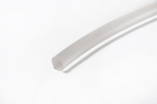 The cut tip of the rubber hose, on a white background.