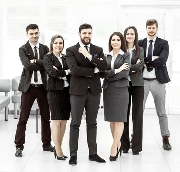 business team standing next to each other and arms crossed in front of him. the photo has a empty space for your text.