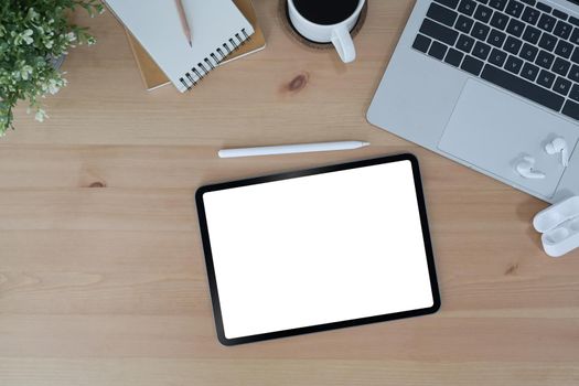 Modern workplace with digital tablet, wireless stylus pen and laptop computer. Top view.