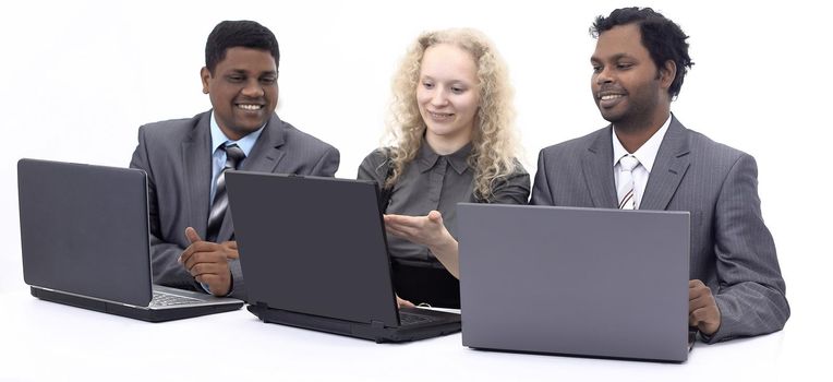 successful business team discussing the information with the laptop .isolated on white