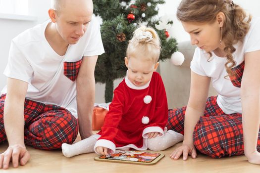 Toddler child with cochlear implant decorating christmas tree deafness and innovating medical technologies for hearing aid