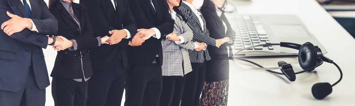 Successful business people standing together showing strong relationship of worker community. A team of businessman and businesswoman expressing a strong group teamwork at office broaden view