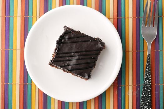 slice of brownie on plate on table .