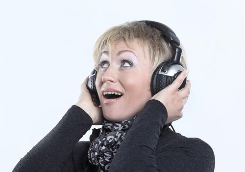 beautiful woman listening to music with headphones.isolated on a white background.