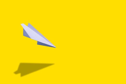 education or innovation concept. paper origami plane over yellow background.