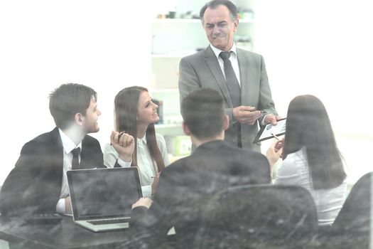 from behind the glass.the image business team at the workshop.business background