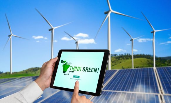 Green business transformation for environment saving and ESG business concept. Businessman using tablet to set corporate goal toward environmental friendly management and alternative clean energy use.