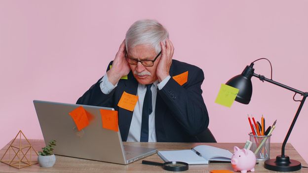 Tired exhausted fatigue senior business man office employee manager sits in office table with laptop sticky notes sticks with many tasks inscription help, feels sad boredom overworked multitasking