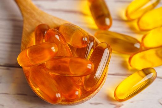 Fish oil or Cod liver oil gel in capsules with omega 3 vitamins, supplementary healthy food 