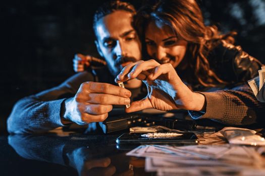 A criminal young couple drug addict prepare cocaine for drugging.