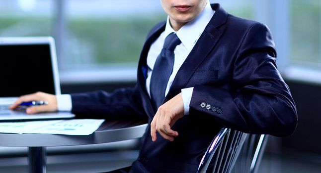 Closeup of businessman typing on laptop computer