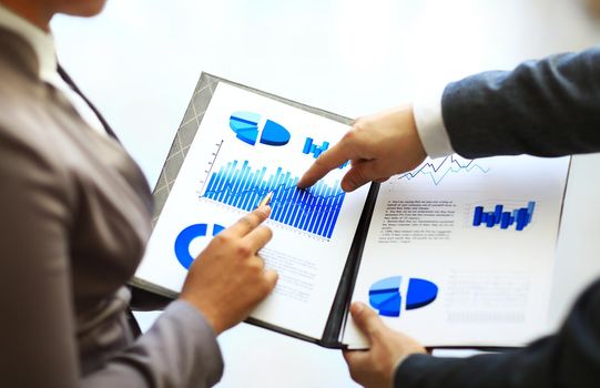 Close-up of graphs and charts analyzed by business people