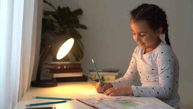 Cute smart primary school child girl learning writing doing math homework sit at home table, adorable pretty little preschool kid studying alone making notes, children elementary education concept