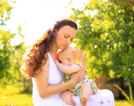 Beautiful Mother And Baby outdoors. Nature. Beauty Mum and her Child playing in Park together