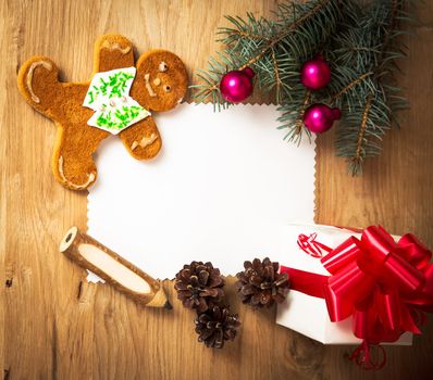 Christmas card: blank, vintage rural gift and Christmas tree branch on wooden background with gift