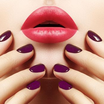 Close-up of woman's Lips with Fashion pink Make-up and Manicure on Nails. Beautiful female full lips with perfect Makeup. Part of female face. Macro shot of beautiful make up on full lips