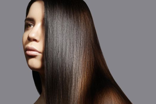 Beautiful young woman with clean skin, beautiful straight shiny hair, fashion makeup. Glamour make-up, perfect shape eyebrows. Portrait sexy brunette. Beautiful smooth hairstyle