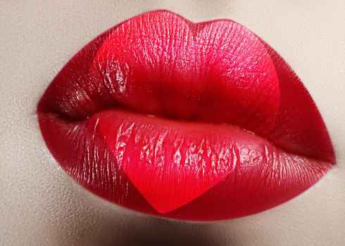 Valentine Heart on beautiful female Lips. Sweet Kiss. Love Makeup for Valntines Day. Cute Shape Heart like Symbol of Love. Celebrate Lip Make-up on macro shoot