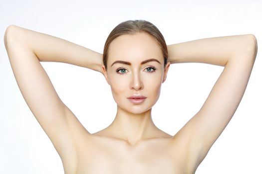 Beautiful woman holding her arms with clean underarms on white background. Epilation smooth skin. Hair removal on arms