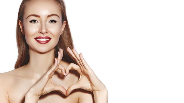 Romantic young Woman making Heart Shape with her Fingers. Love and Valentines Day Symbol. Fashion girl with Happy Smile on white background.