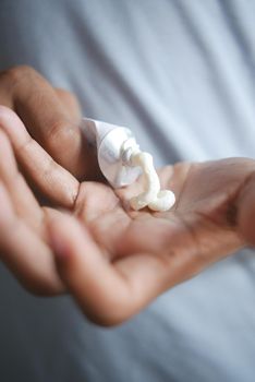 Man applying antibiotic cream close up.