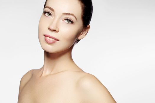 Beautiful face of young woman. Skincare, wellness, spa. Clean soft skin, healthy fresh look. Natural daily makeup.