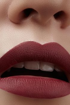 Close-up of woman's lips with fashion red make-up. Beautiful female mouth, full lips with perfect makeup. Classic visage. Part of female face. Macro shot of beautiful make up on full lips.