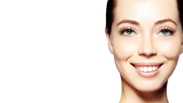 Beautiful face of young woman. Skincare, wellness, spa. Clean soft skin, healthy fresh look. Natural daily makeup. Happy smiling woman