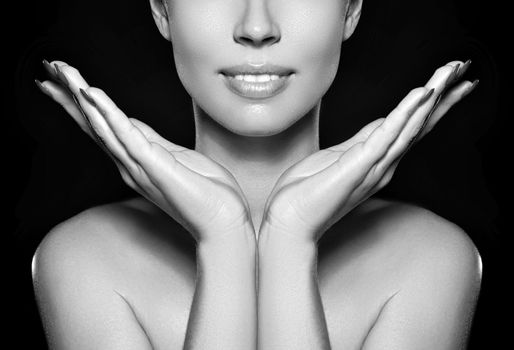 Beautiful woman show her erfect face with fashion make-up on dark grey background. Extreme eyelashes, plump lips, clean skin. Fresh spa look
