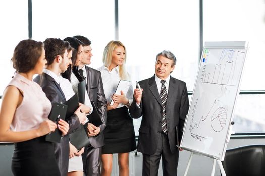 A group of businessmen discussing the policy of the company in the office.
