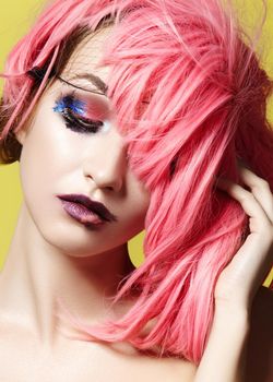 Dramatic Fashion Look young Woman in Pink Wig. Beautiful Model with bright Make-up. Theatrical style, Carnival Accessories for Halloween